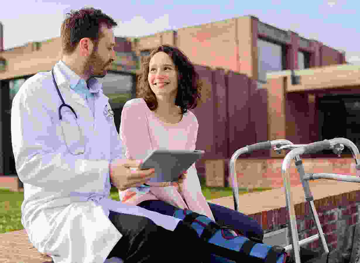 A doctor and patient sitting on the side of a road.