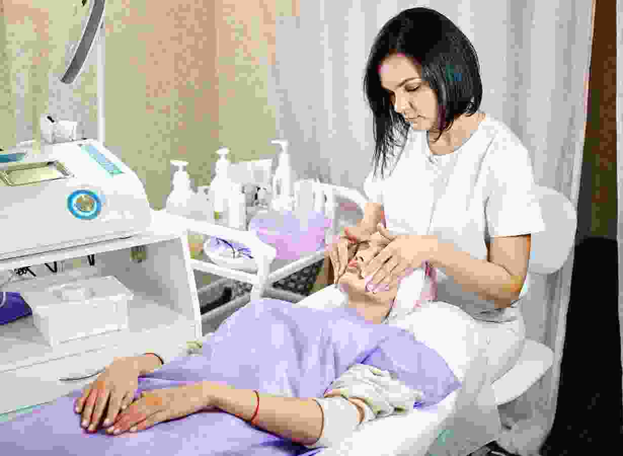 blog-10 A woman is sitting on the bed while another person sits in front of her.