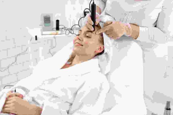 A woman is getting her hair done by a stylist.