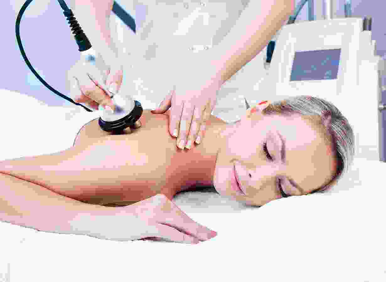A woman getting her back examined by an esthetician.