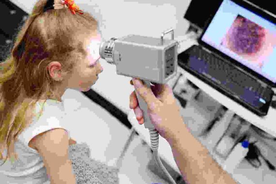 A child is being examined by an optometrist.