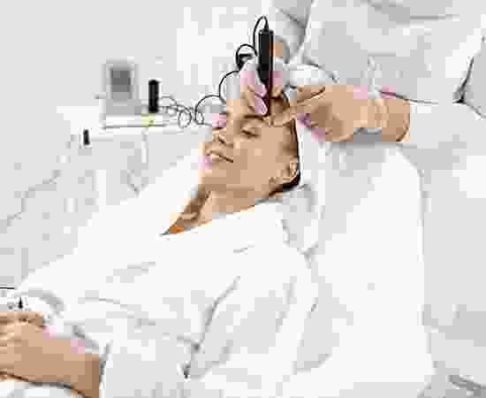 blog-detail-11 A woman is getting her hair cut by an esthetician.