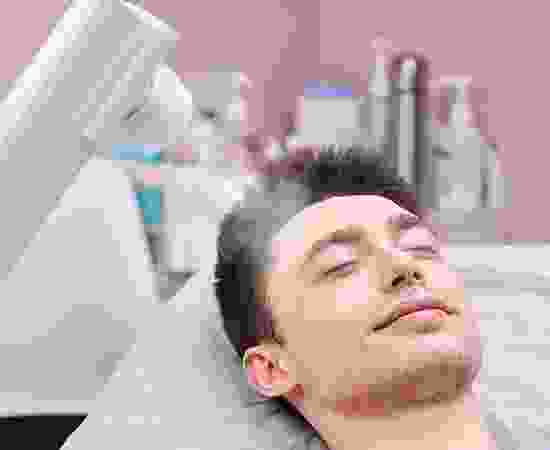 blog-detail-8 A man with his eyes closed in the middle of a procedure.